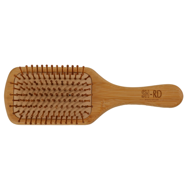 A wooden hairbrush with brown bristles, featuring the brand name 'SH-RD' engraved on the handle, set against a plain white background.