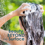 A person washing their hair with foamy shampoo outdoors, with green foliage in the background and the text 'Beauty BEYOND the Surface' overlaid on the image.
