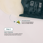 A close-up of a dark teal shampoo packet labeled SH-RD Nutra-Therapy Shampoo, with a curved arrow pointing to text describing avocado extract benefits. A dollop of creamy shampoo is shown above, and the text reads Step 2 Hair Cleanse on a light beige background.
