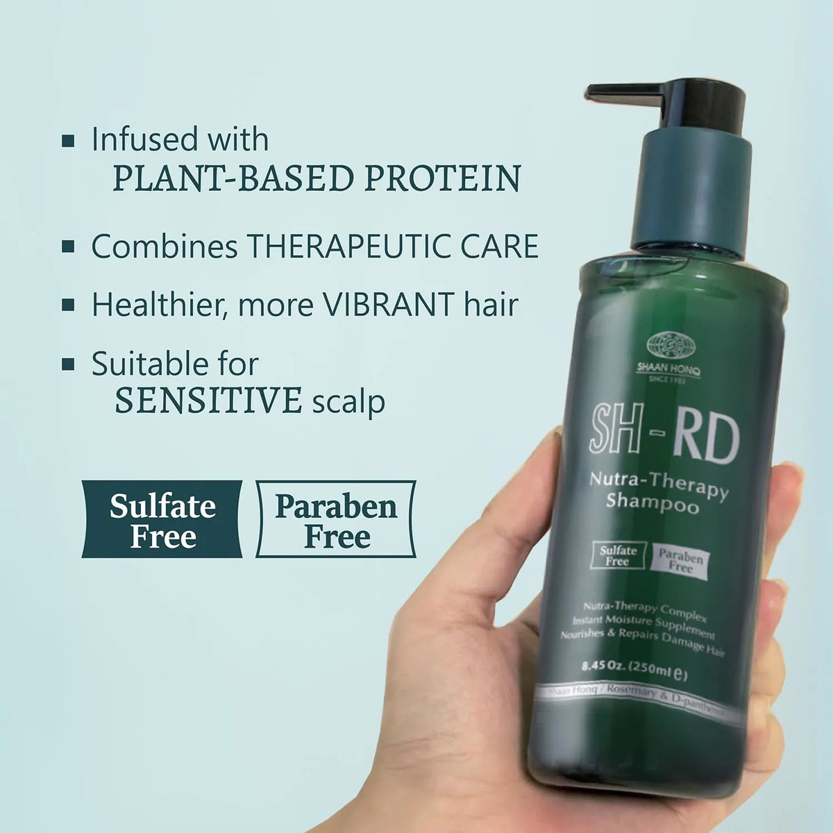 Green shampoo bottle held in a hand with product features listed on a light blue background