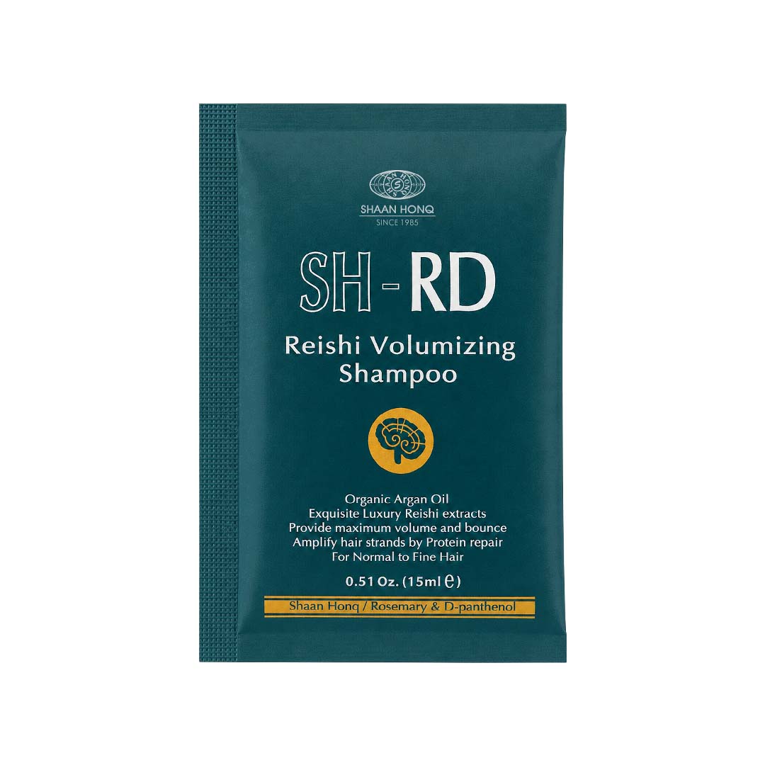 A single packet of Shaan Hong SH-RD Reishi Volumizing Shampoo in a dark teal-green color, featuring white text and a small yellow circular logo, on a plain white background.